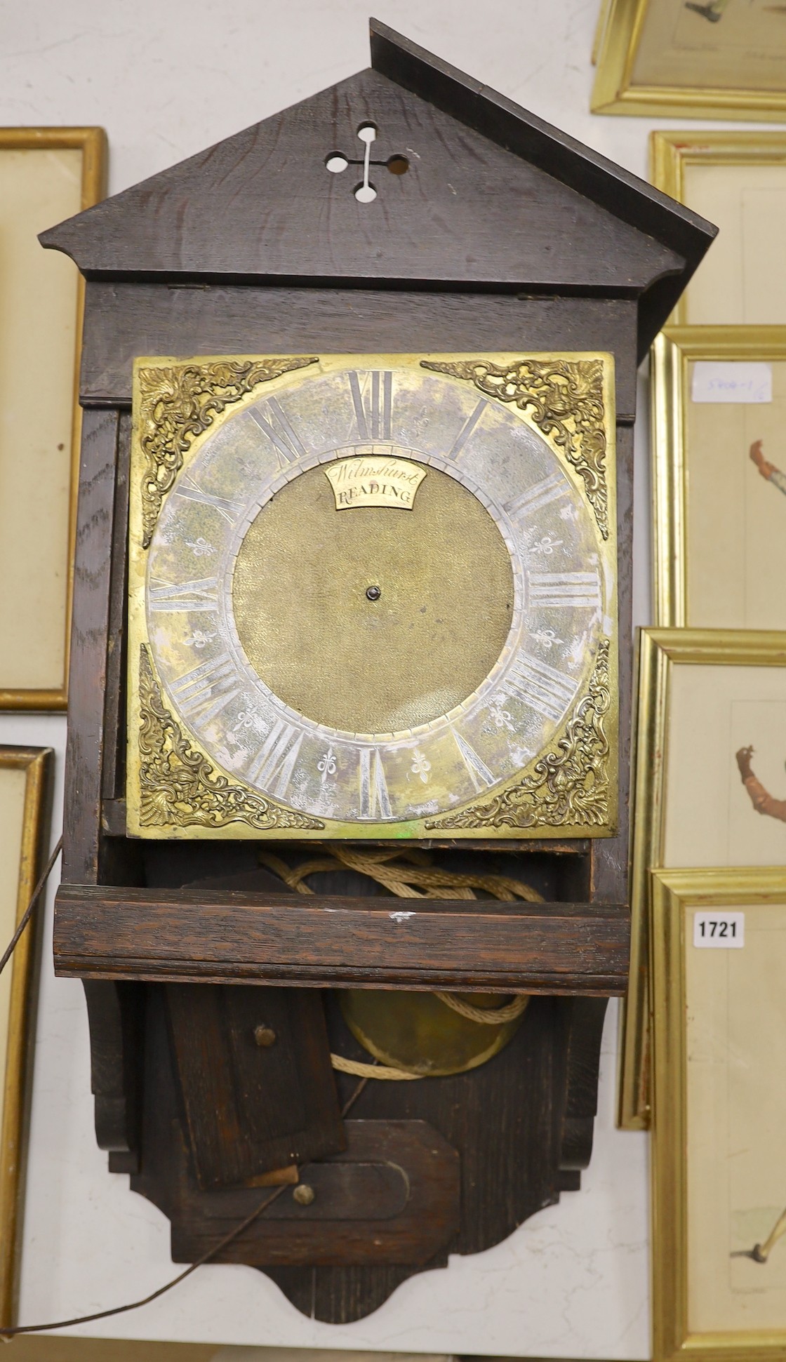 A thirty hour oak hooded wall clock, signed Wilmhurst, Reading
